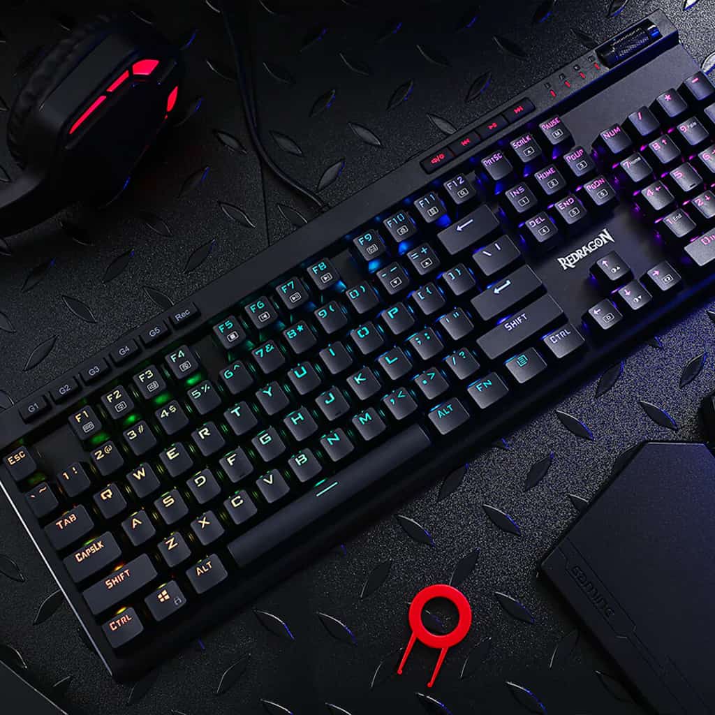 Redragon K580 Vata, emphasizing its robust design, full functionality with specialized keys and its customizable RGB illumination
