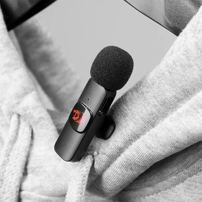 Microphone clipped to a gray sweater
