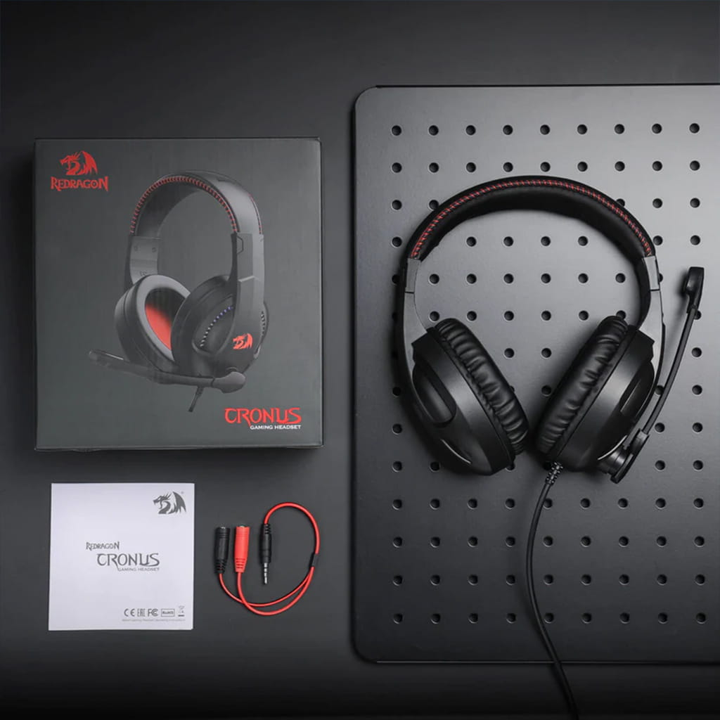 Contents of Redragon H211 Cronus RGB gaming headset box including the black and red headset, manual & audio cable with connectors