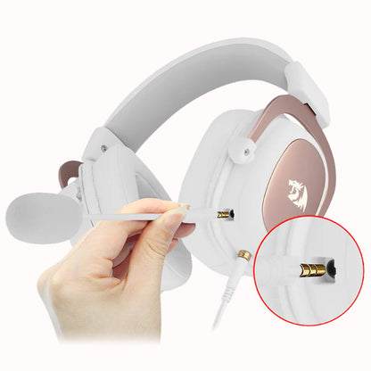 Image showing a 3.5mm jack cable being connected to the earcup of the white Redragon H510 Zeus headset, demonstrating the detachable cable feature