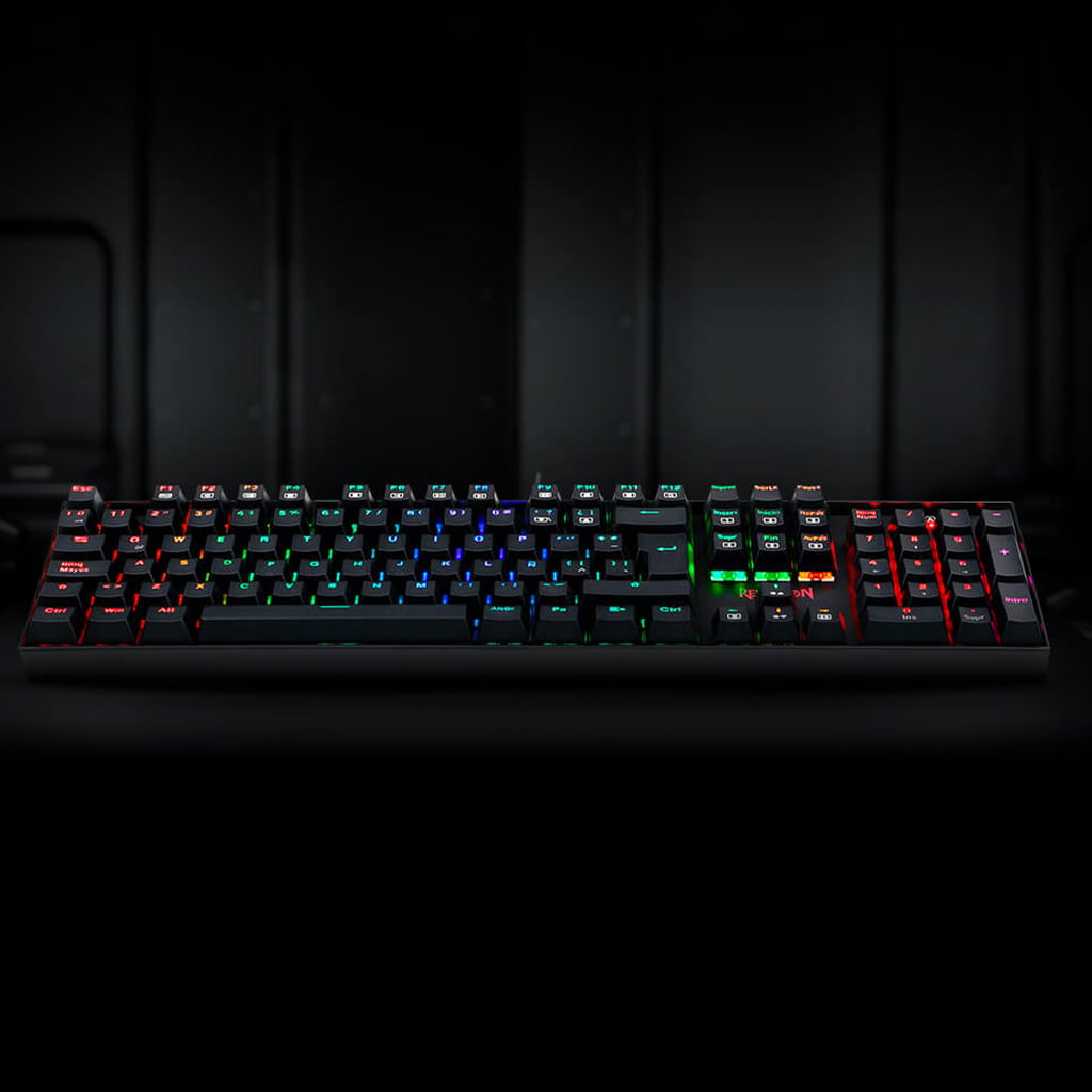  Redragon K551 MITRA RGB 104-key mechanical keyboard, showcasing the complete layout and dynamic RGB lighting across all keys.