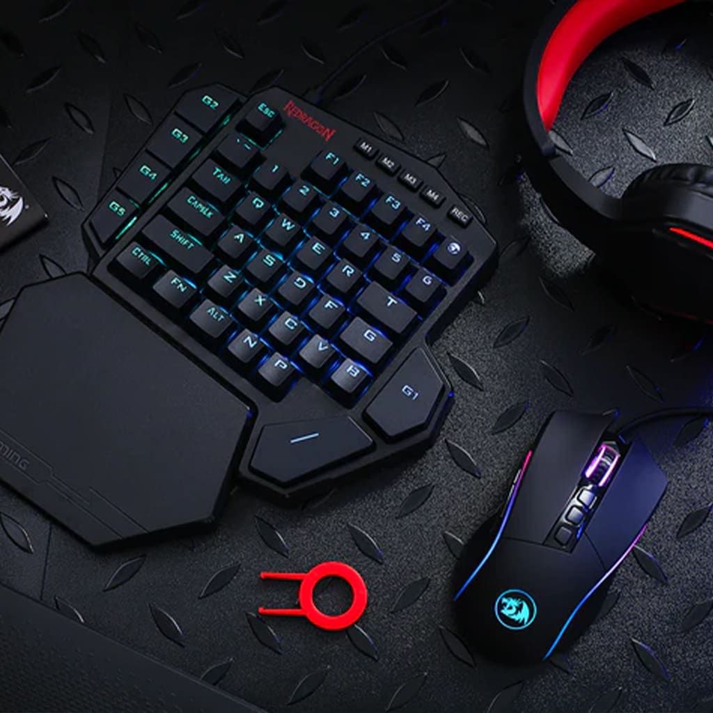 Redragon K585-BA keyboard paired with M721-Pro mouse, showcasing keycap putter with headset H220 on a dark surface