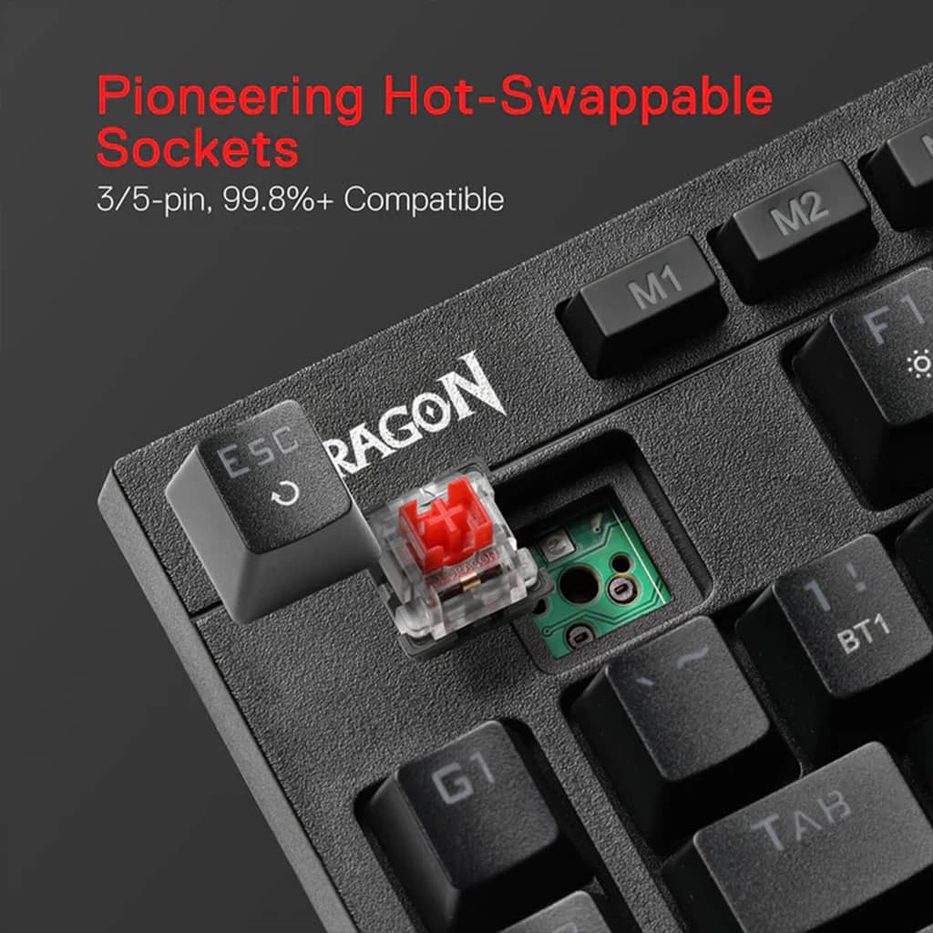 Redragon K596 Keyboard showing hot-swappable switch socket with red mechanical switch removed, compatible with 3/5-pin switches