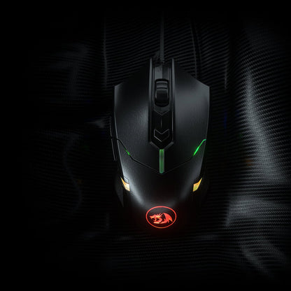 Top-down view of the black Redragon M601 Centrophorus RGB  mouse on a textured surface, showcasing its design & RGB lighting 