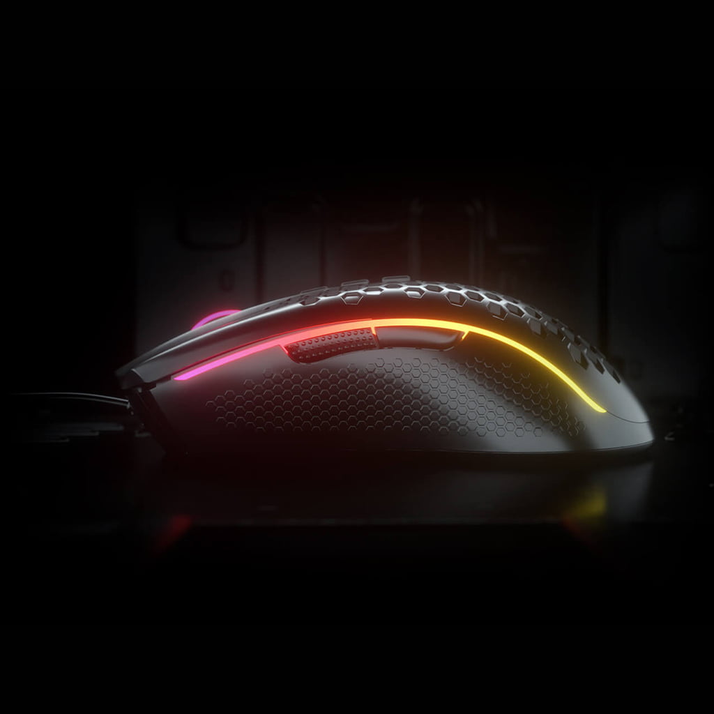 Redragon M988 Storm Elite RGB mouse from the side in a dark setting, showing the honeycomb shell & illuminated RGB lighting strip